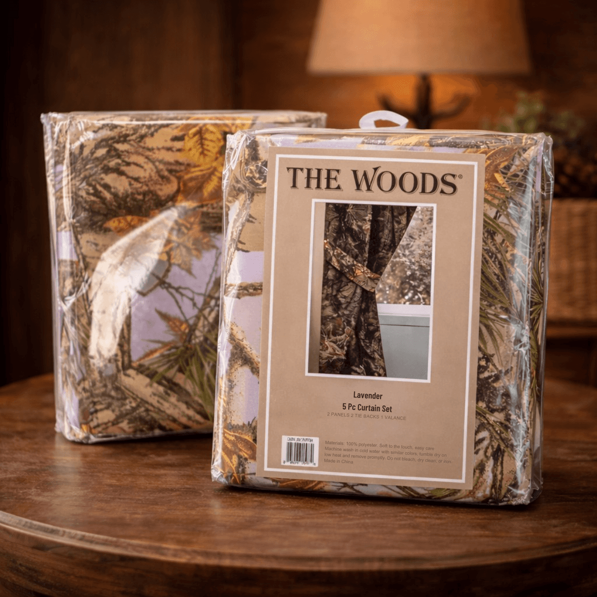 Packaged curtain set with 'The Woods' branding on a wooden surface.