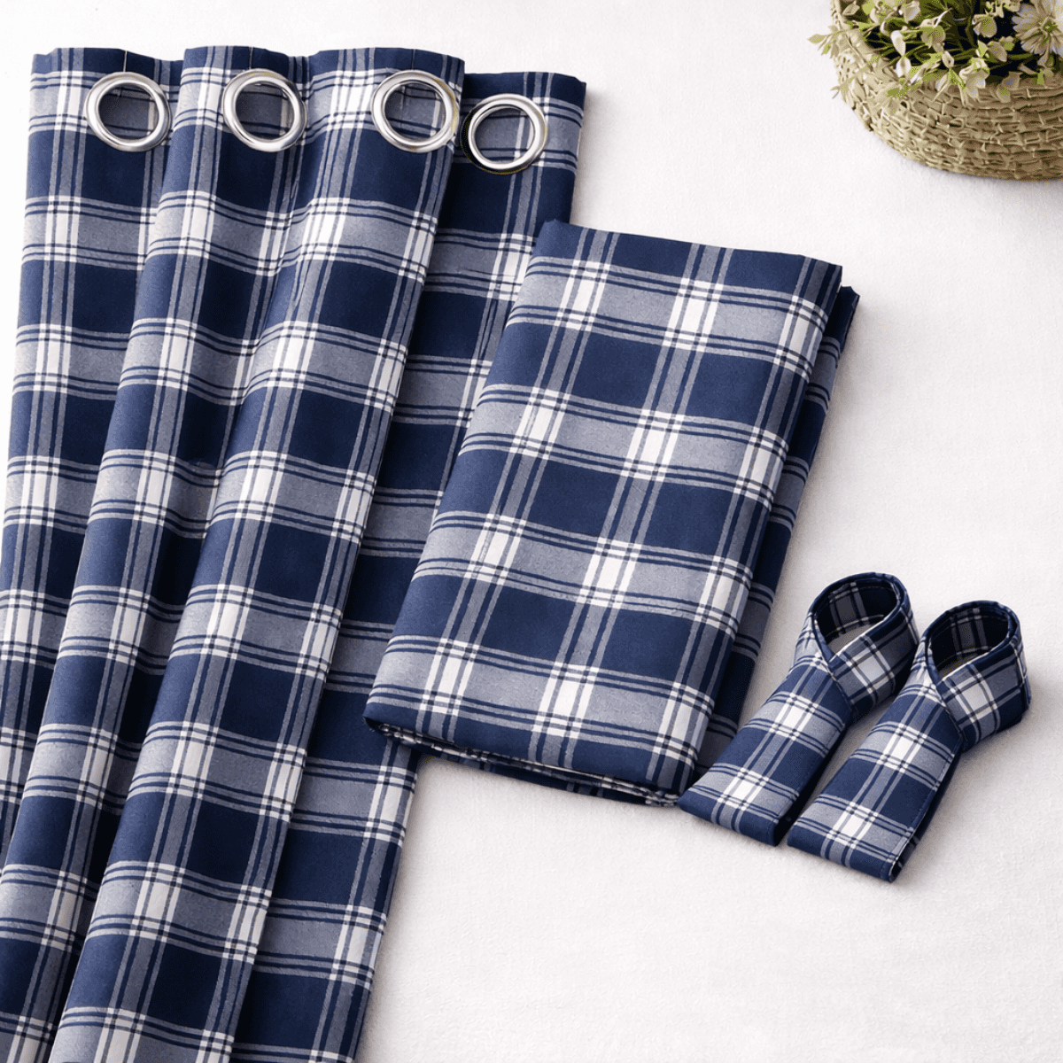 Blue and white plaid curtains with grommets on a light background