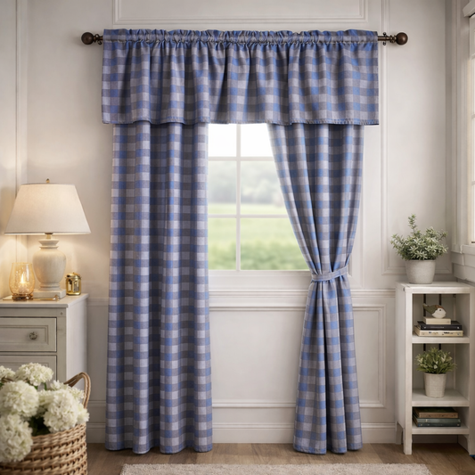 Blue checkered curtains hanging in a room with a lamp and small table.