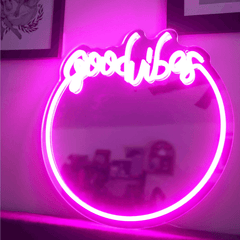 Backlit 'Good Vibes' neon sign with mirror frame