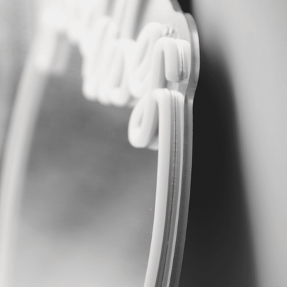 Close-up of white neon 'Good Vibes' sign with mounting clips