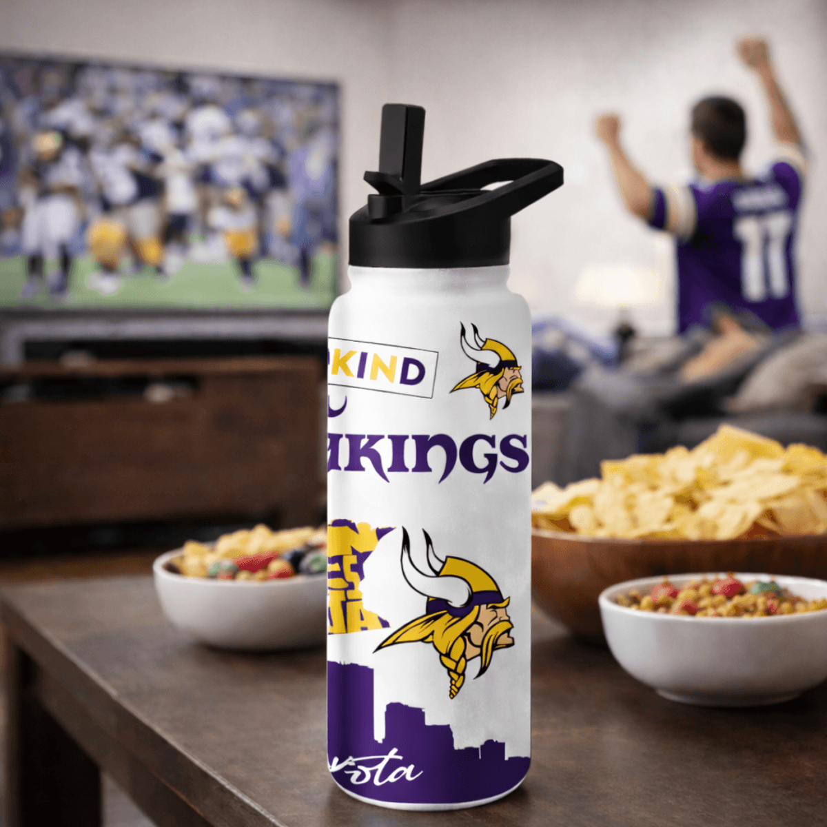 Minnesota Vikings water bottle on a table with snacks and TV in the background