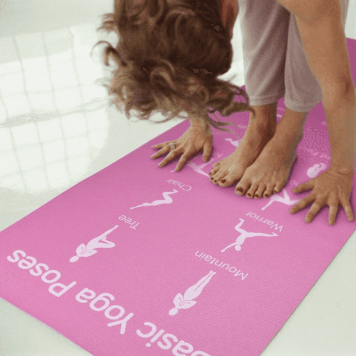 Yoga practitioners using pink chakra art yoga mats in meditation