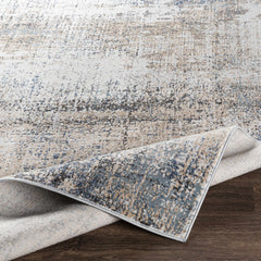 Light-colored abstract rug on dark wood