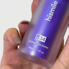 Close-up of hand holding Hismile V34 purple teeth serum bottle