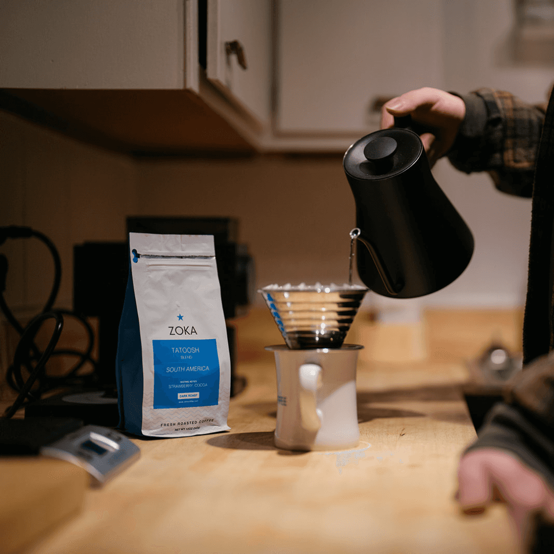 Person brewing coffee with Zoka Tatoosh coffee bag and pour-over setup
